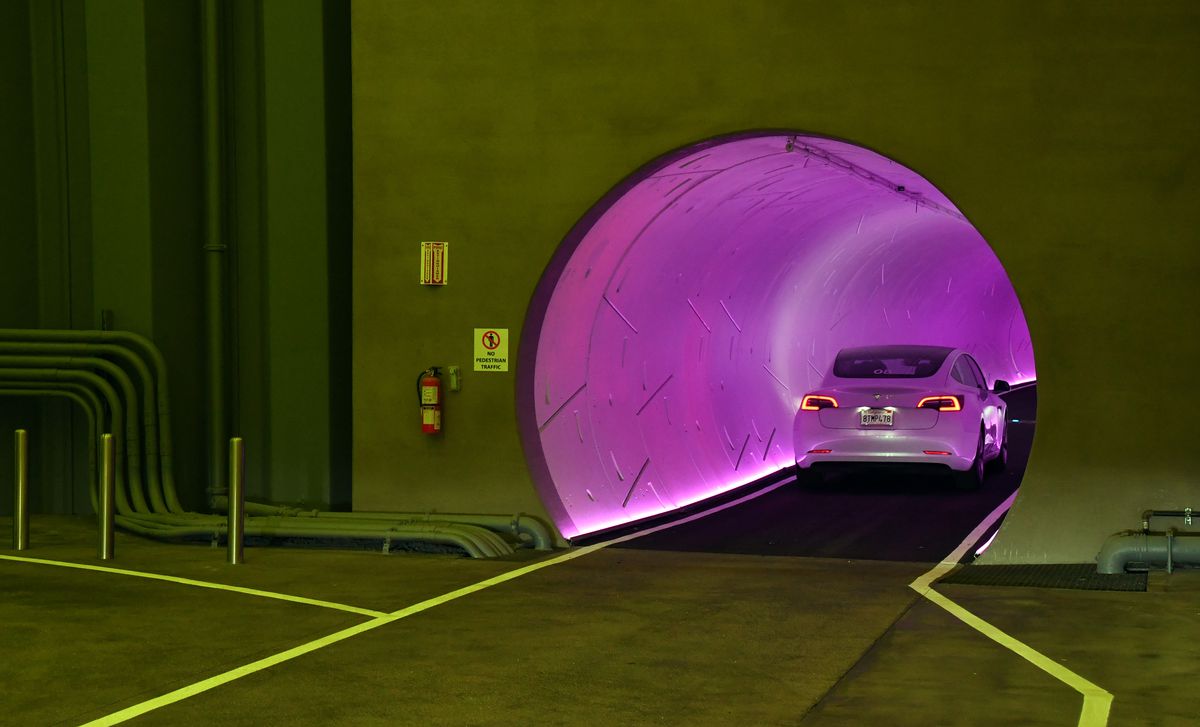 A Tesla drives through the entrance of a Boring Company tunnel underneath the Las Vegas Convention Center.
