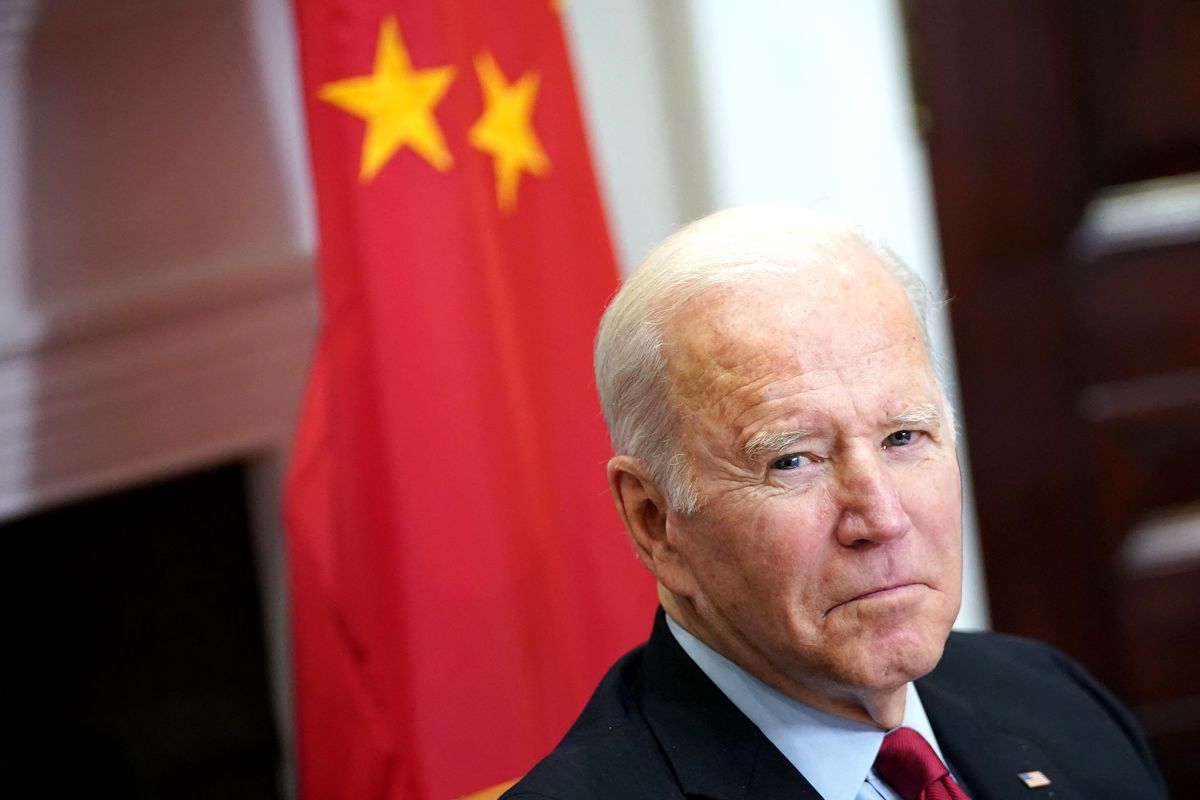 President Joe Biden in front of the Chinese flag.