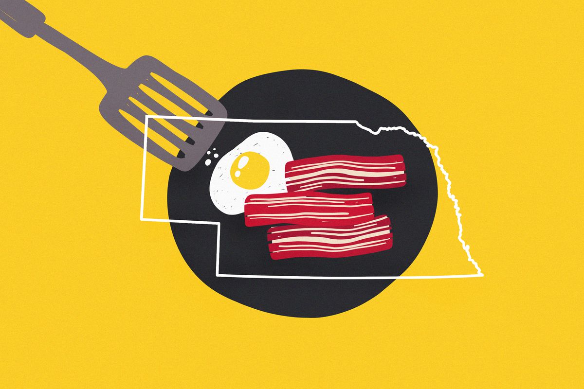 A colorful illustration shows a black pan and metal spatula with bacon and eggs, with the outline of the state Nebraska over it, all on a yellow background.