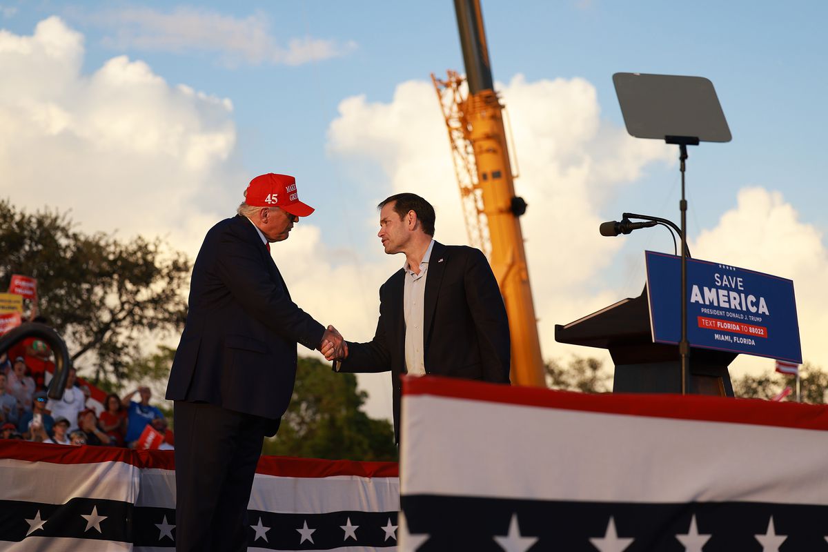 Sen. Marco Rubio (R-FL) shakes hands with former President Donald Trump at a recent rally.