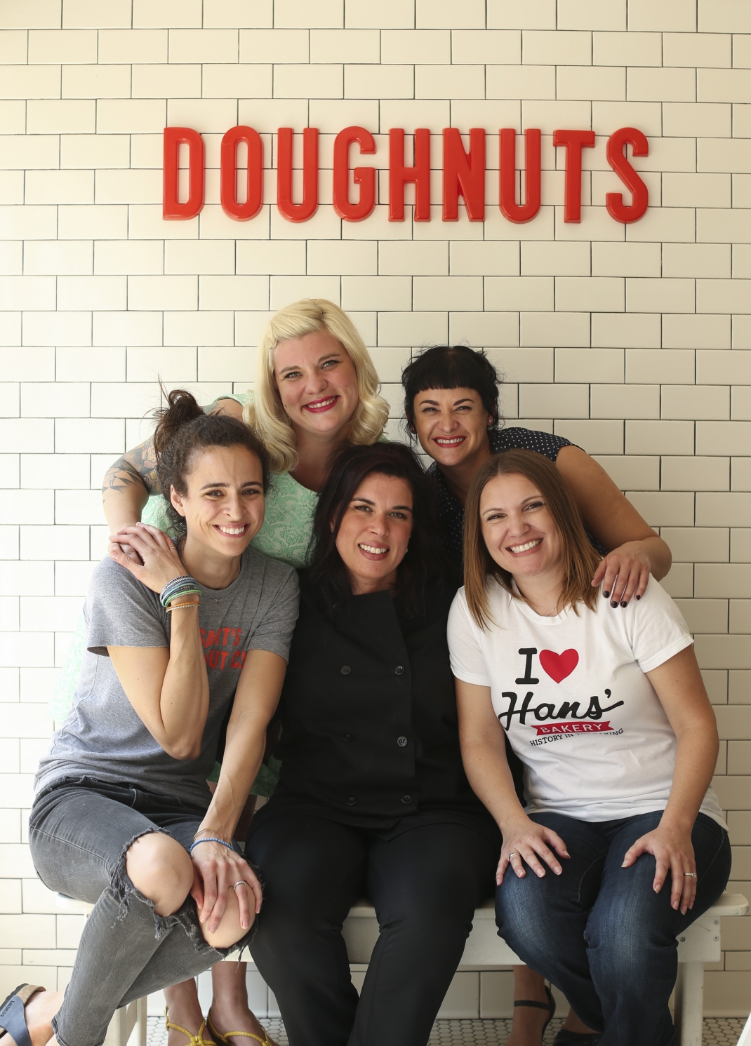 These five women have taken the Twin Cities doughnut scene to new levels. Front row, from left: Anne Rucker of Bogart’s Doughnut Co., Lisa Clark of Mojo Monkey Donuts and Kelly Olsen of Hans’ Bakery. Back row (from left): Teresa Fox and Arwyn Birch of Glam Doll Donuts.