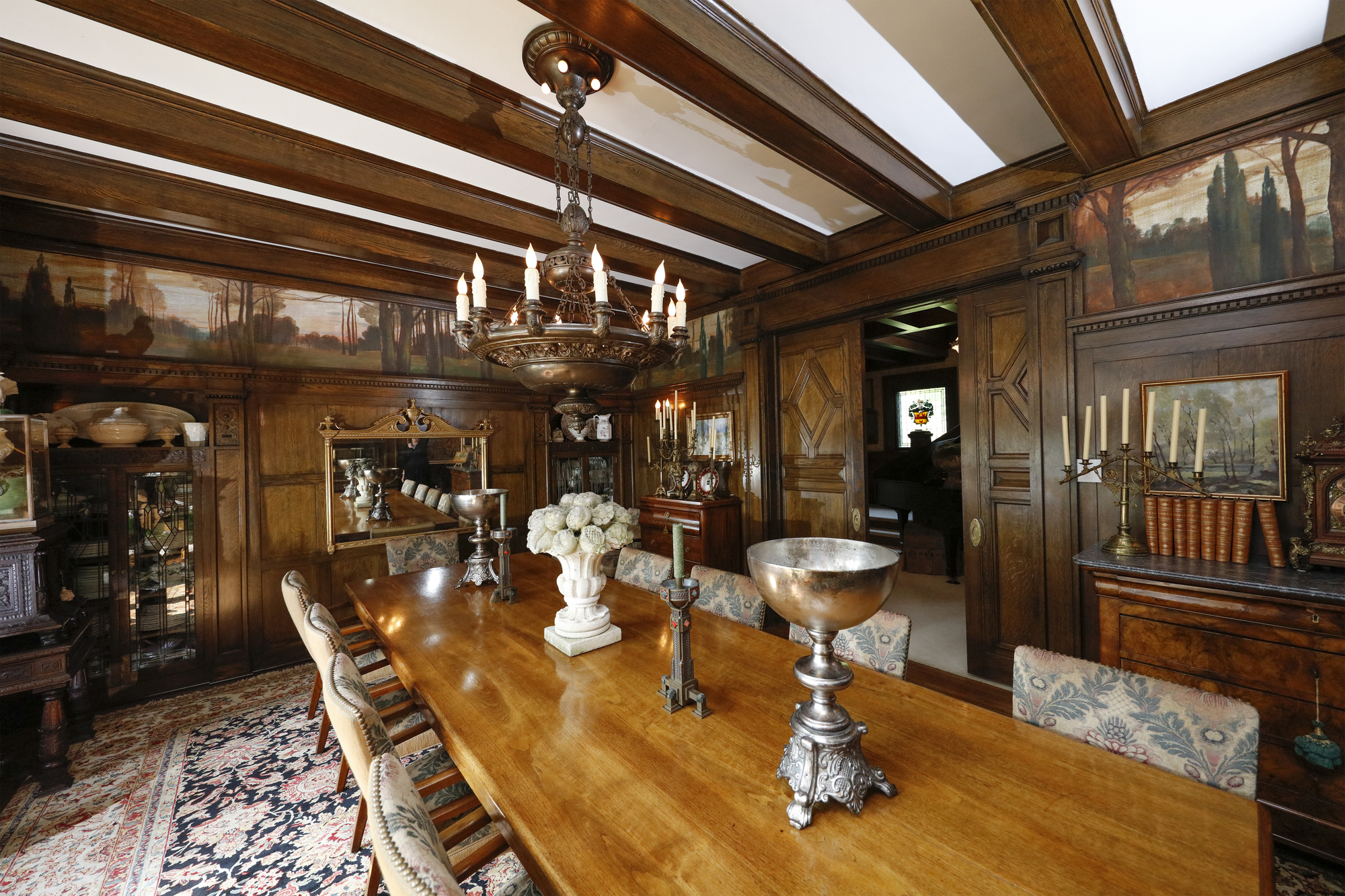 The dining room in the Wilsey family's Summit Avenue home features carved woodwork and beams, built-ins and an original handpainted mural.