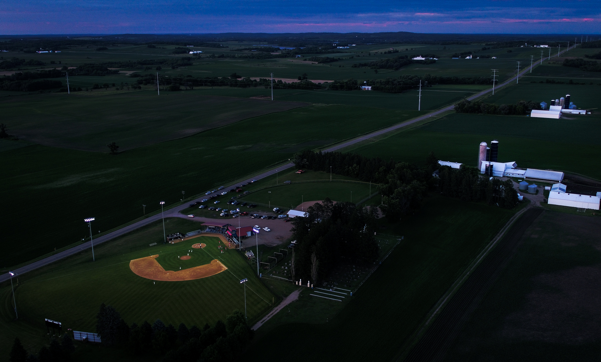 The Farming Flames Baseball Field was illuminated as the sun set on Friday, June 23, 2017 in Farming, Minn. during a tournament game between the Farming Flames and the Sartell Muskies.