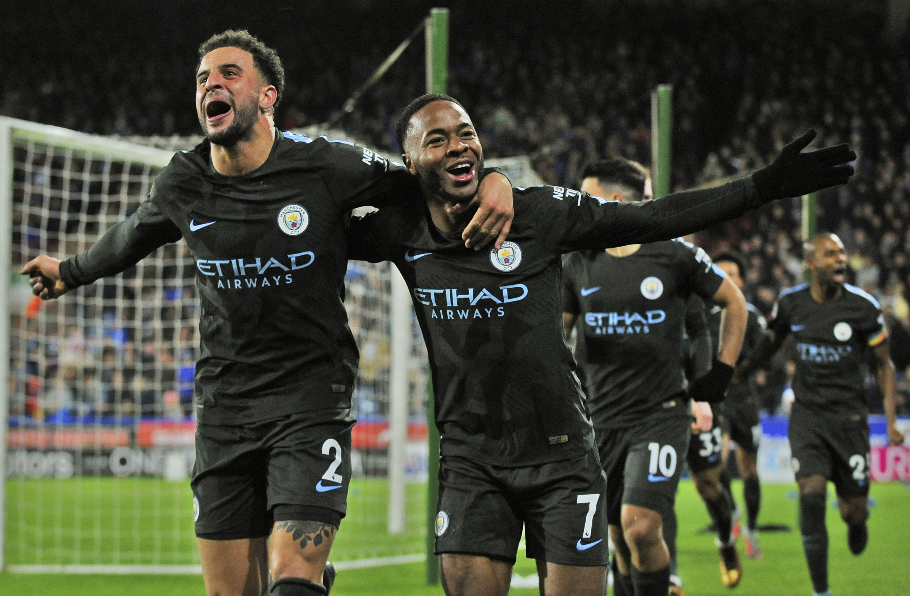 Manchester City's Raheem Sterling, right, celebrated with teammate Kyle Walker after scoring during the English Premier League soccer match between Huddersfield Town and Manchester City in Huddersfield, England, on Sunday. Man City equaled a club record with its 11th consecutive league victory.