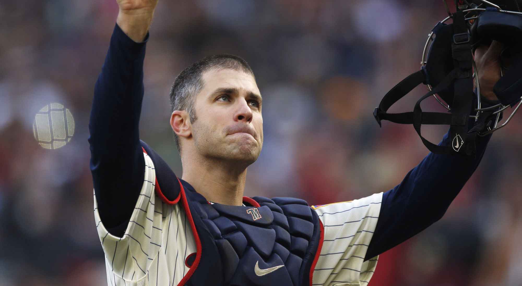 Joe Mauer acknowledges a standing ovation as he donned catcher’s gear and caught for one pitch against the Chicago White Sox