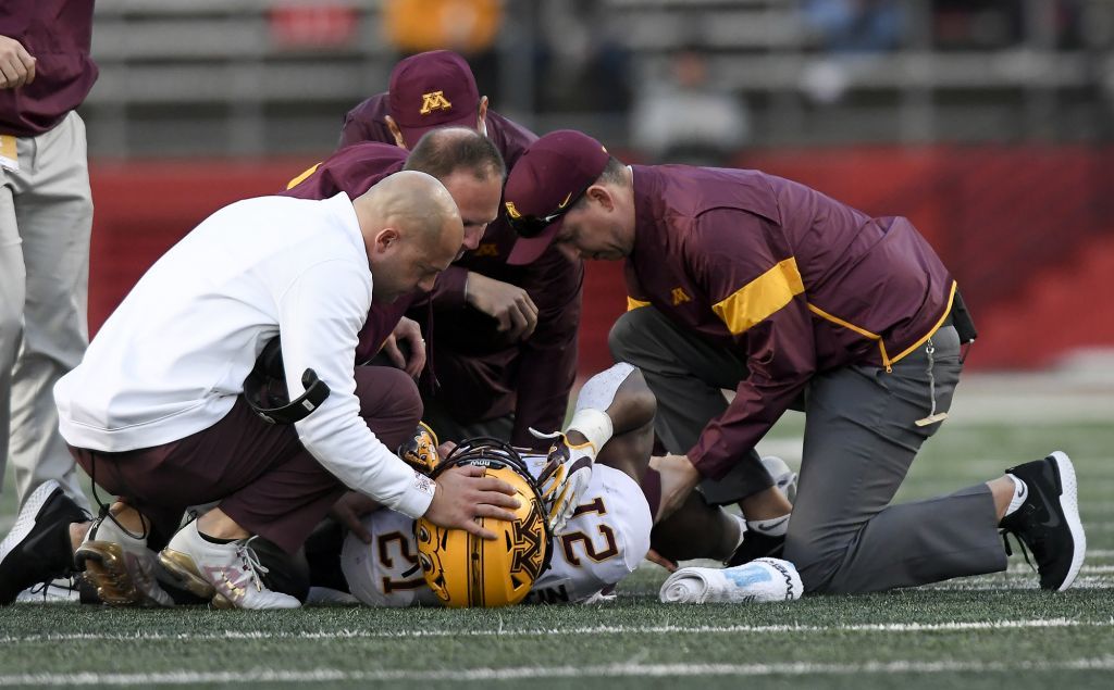 P.J. Fleck visits linebacker Kamal Martin (21) as he is injured on the field in the third quarter against Rutgers on Saturday.