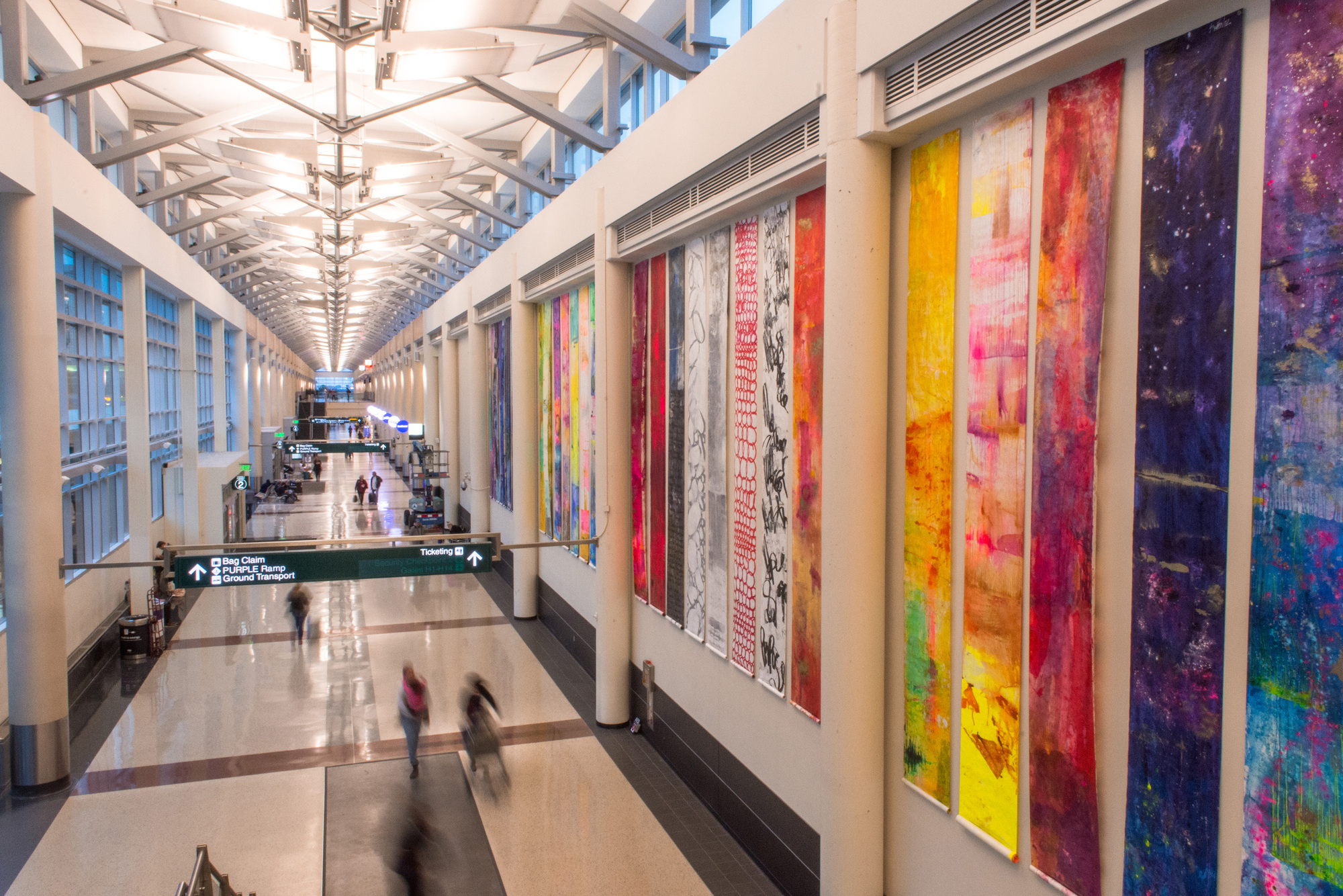 Scrolls from “122 Conversations,” by Anne Labovitz, greet passengers at the entrance to Terminal 2.