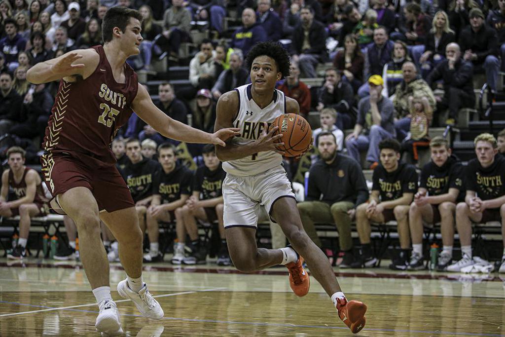 Prior Lake's Tyree Ihenacho (right) took the ball to the basket, looking for a way around Lakeville South's Riley Mahlman.