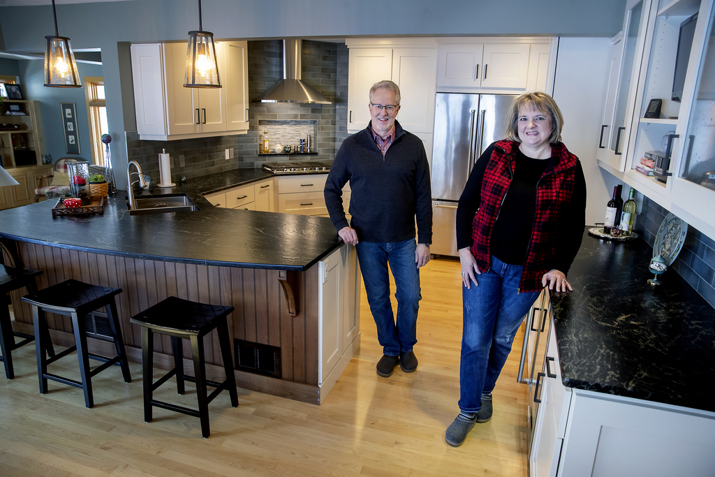 Sue and Mark Read in the newly remodeled kitchen of their Deephaven home. With their children in college, the couple considered a move. Instead, they decided to give their kitchen a fresh new look.