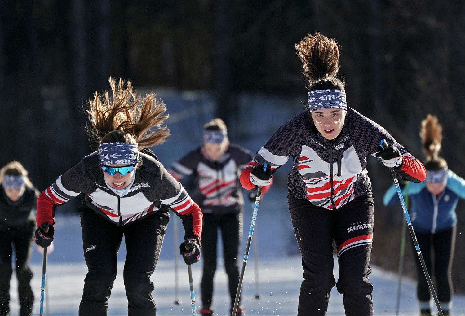 Stillwater High School Nordic team members Libby Tuttle and Louisa Ward going through drills at Lake Elmo Park Reserve Nordic Center. The team remains gaga for its famous alum.