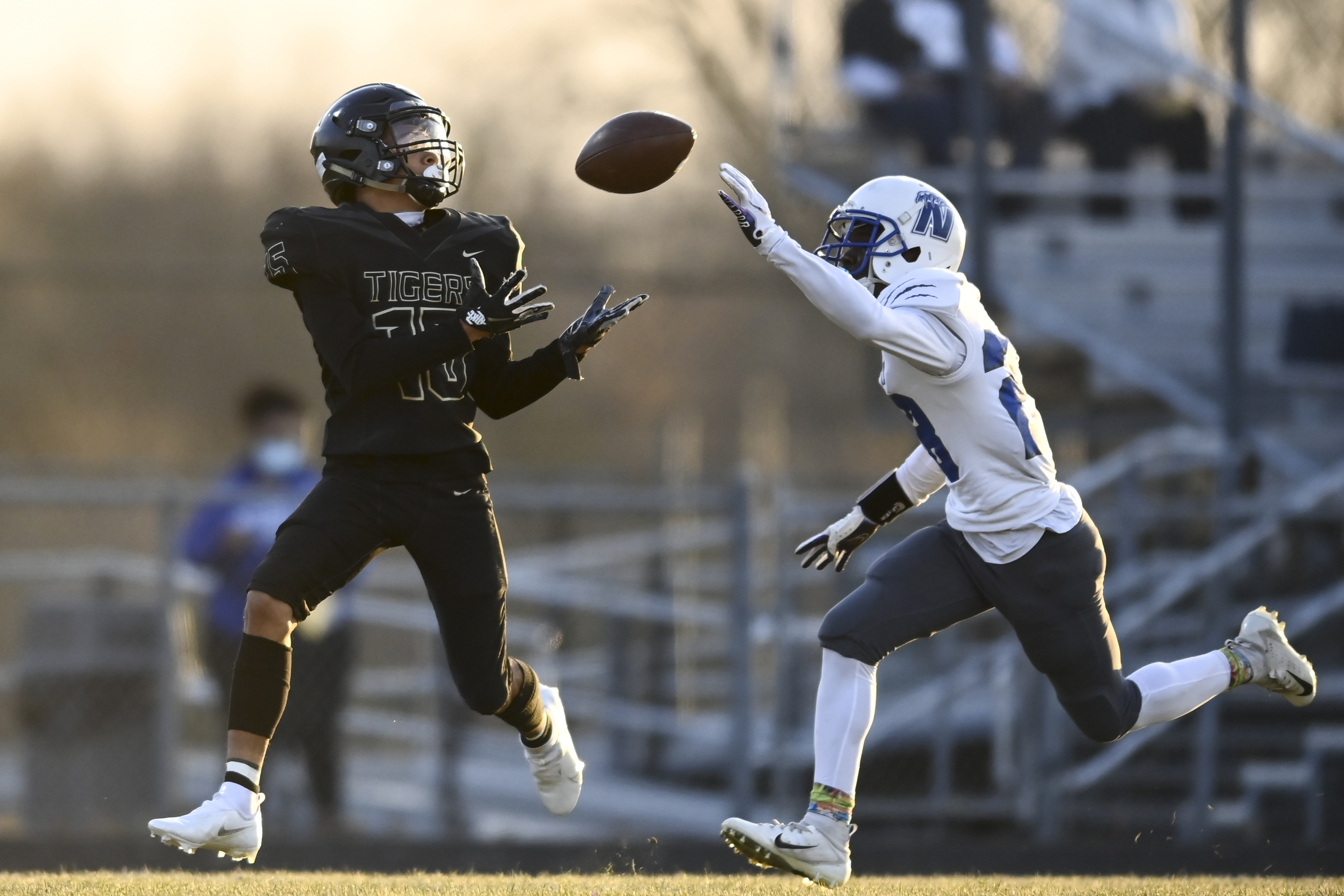 Fridley wide receiver Christian Crockett (15) caught the ball for a 46-yard completion as he was defended by Minneapolis North’s Javion Hill (28) in