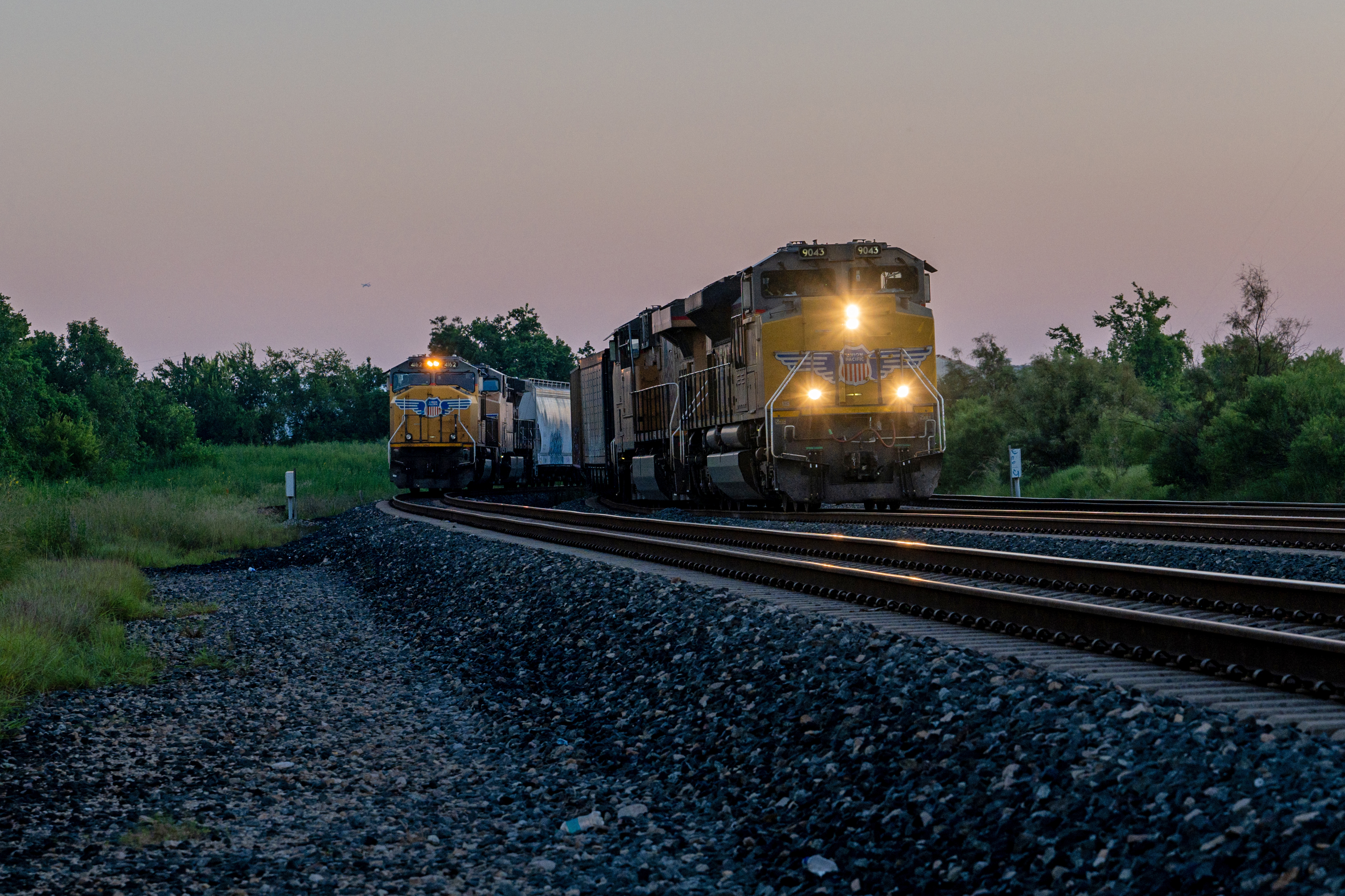 Two freight trains on parallel tracks.