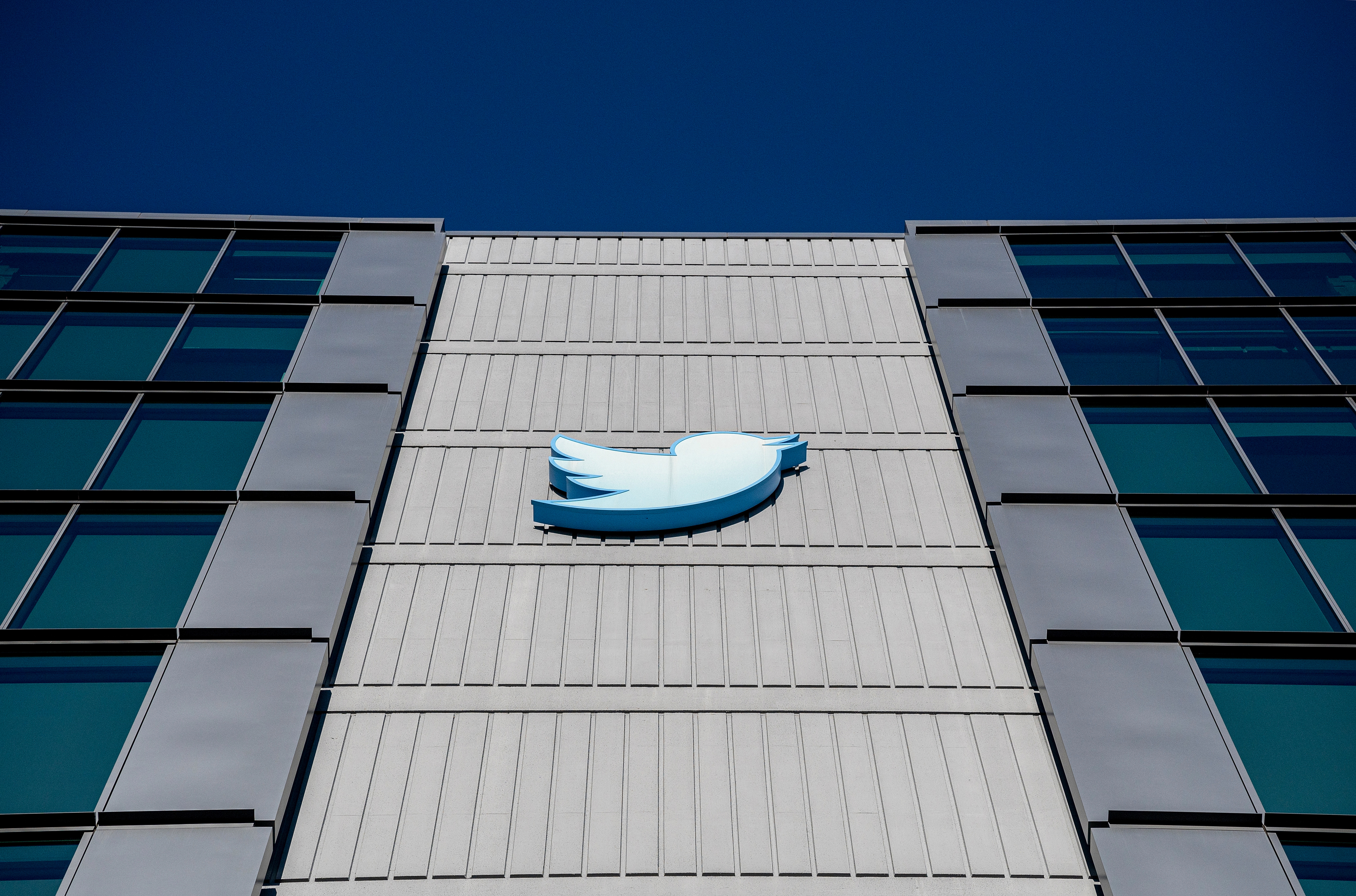 The exterior of the Twitter building in San Francisco, featuring the blue Twitter bird logo high up on the wall.
