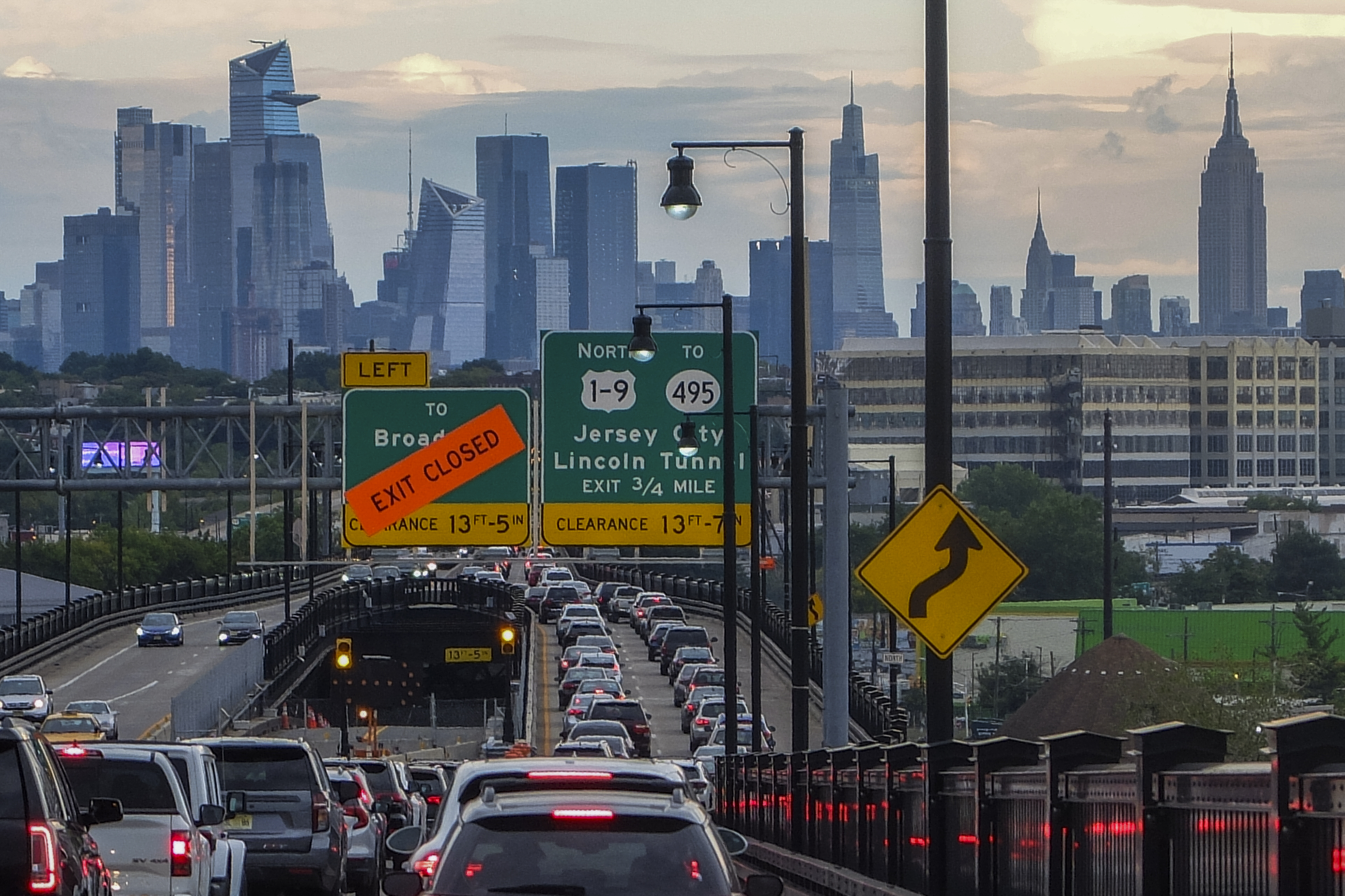 The Empire State Building and tourist district skyline are seen from a traffic jam along the route to New York City on August 17, 2022, in Jersey City, New Jersey.