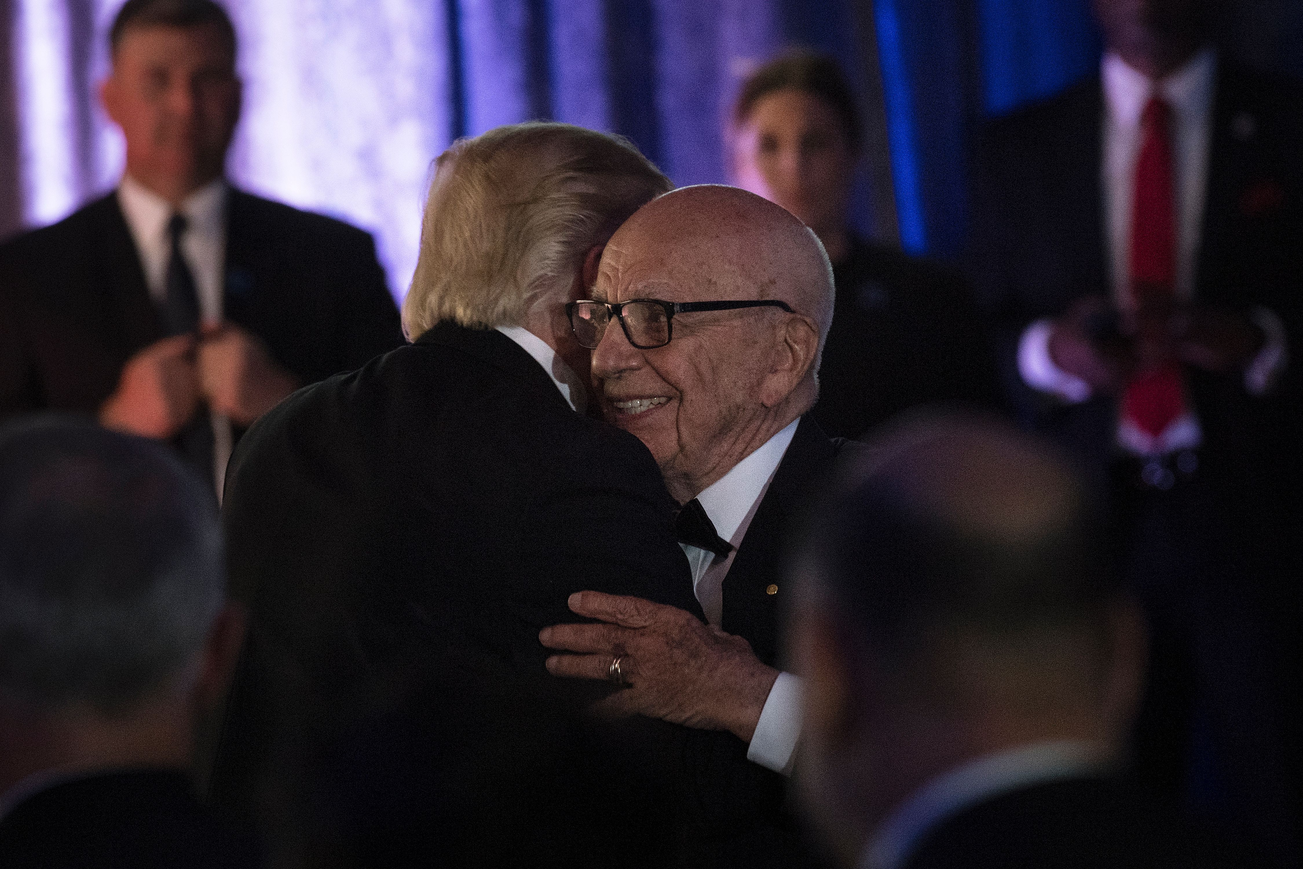 US President Donald Trump (L) is embraced by Rupert Murdoch, Executive Chairman of News Corp, during a dinner to commemorate the 75th anniversary of the Battle of the Coral Sea during WWII onboard the Intrepid Sea, Air and Space Museum May 4, 2017 in New York, New York.