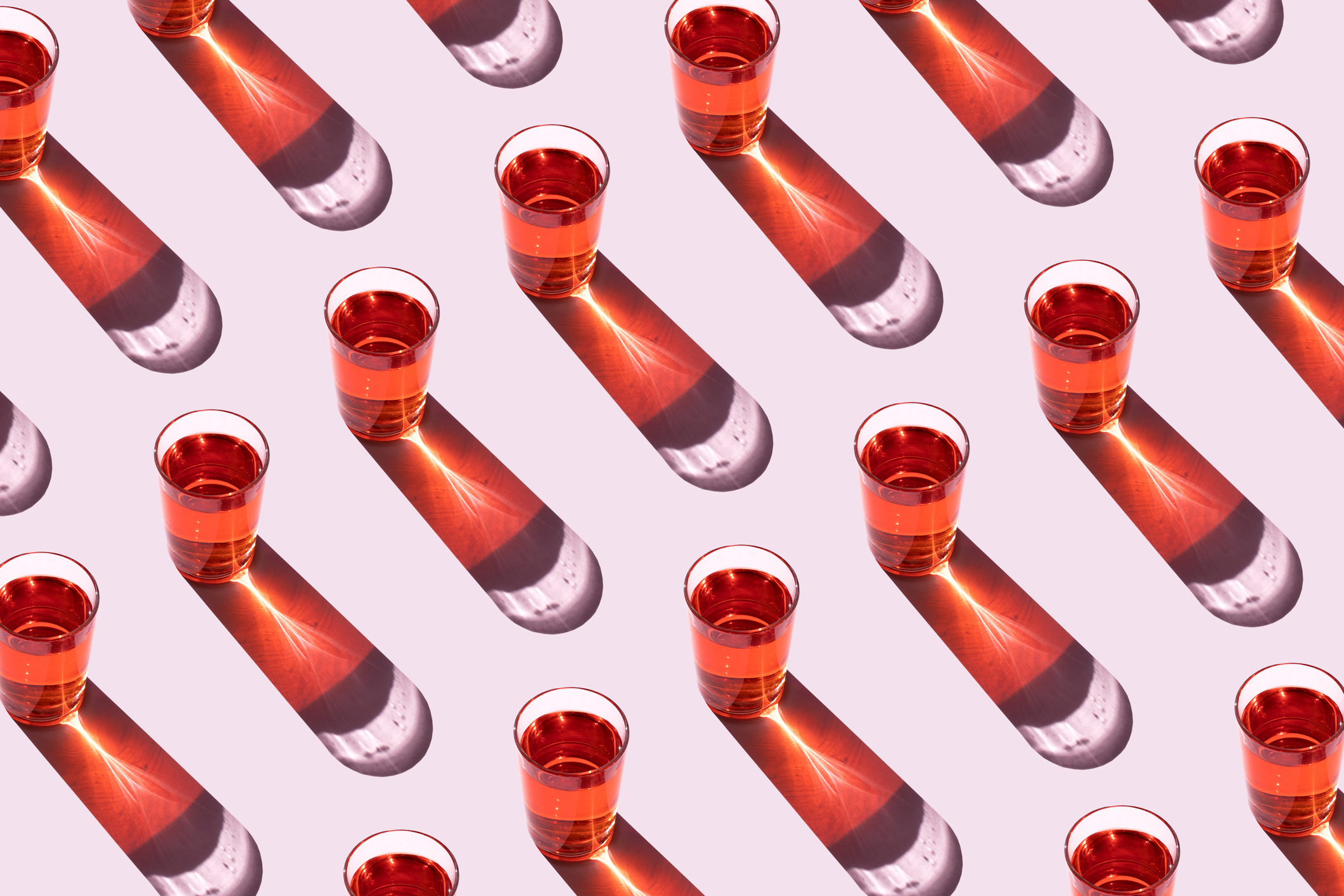 Rows of red-tinted glasses of water.