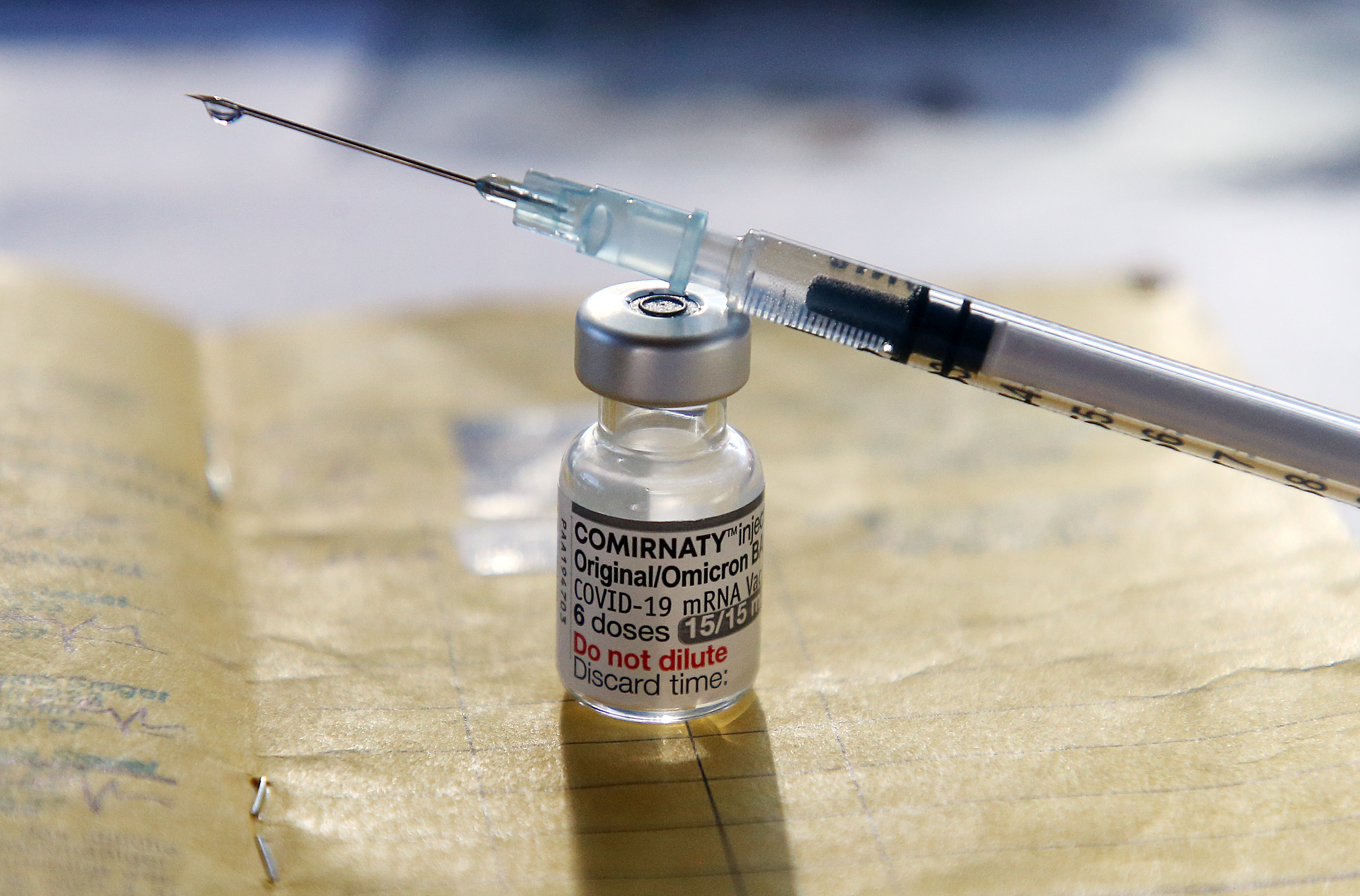 A syringe and a vial of vaccine.