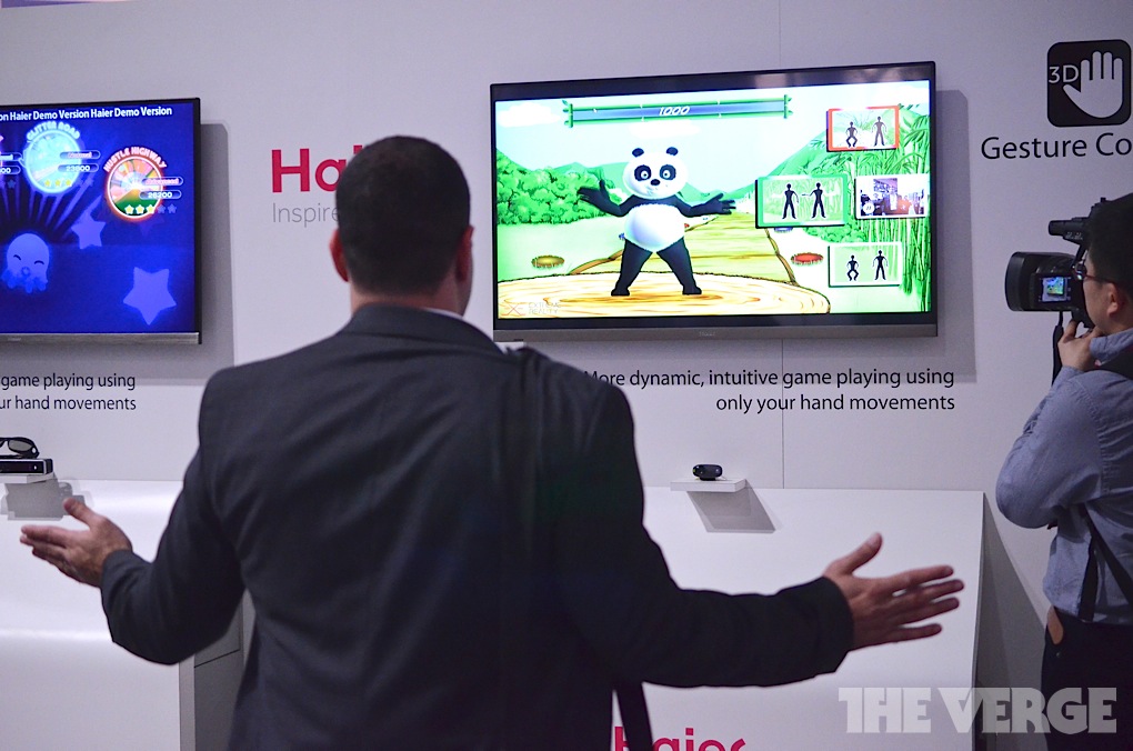 A CES-goer tries out Haier's gesture control TV