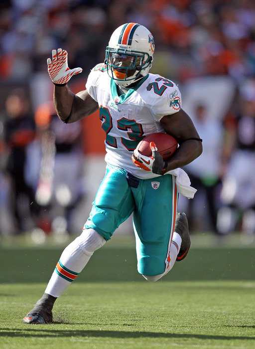Ronnie Brown gives high fives to invisible teammates while carrying the ball.  Red flag, anyone?