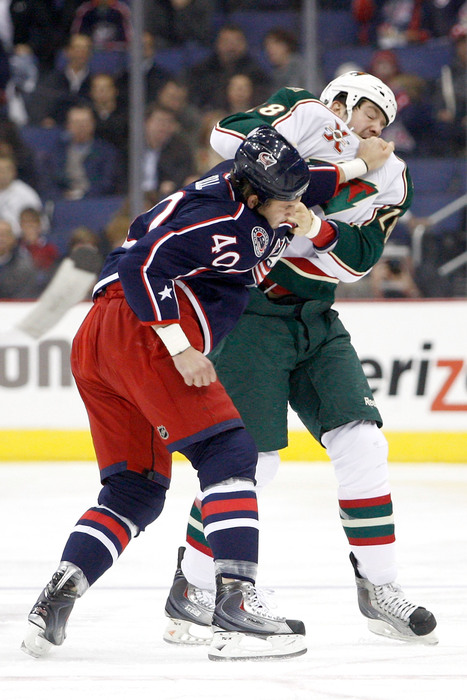 COLUMBUS OH - NOVEMBER 6:  Jared Boll #40 of the Columbus Blue Jackets fights with Matt Kassian #28 of the Minnesota Wild during the first period on November 6 2010 at Nationwide Arena in Columbus Ohio.  (Photo by John Grieshop/Getty Images)
