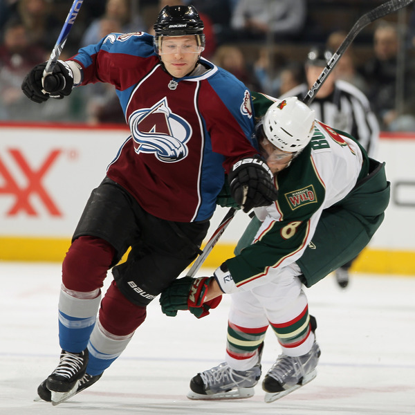 DENVER - DECEMBER 23:  Kevin Porter #12 of the Colorado Avalanche brushes off Brent Burns #8 of the Minnesota Wild as they vie for the puck at the Pepsi Center on December 23 2010 in Denver Colorado.  (Photo by Doug Pensinger/Getty Images)