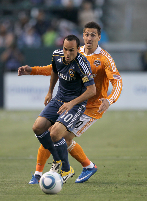 CARSON, CA - MAY 25:  Landon Donovan #10 of the Los Angeles Galaxy looks for the ball in front of Geoff Cameron #20 of the Houston Dynamo at The Home Depot Center on May 25, 2011 in Carson, California.  (Photo by Stephen Dunn/Getty Images)
