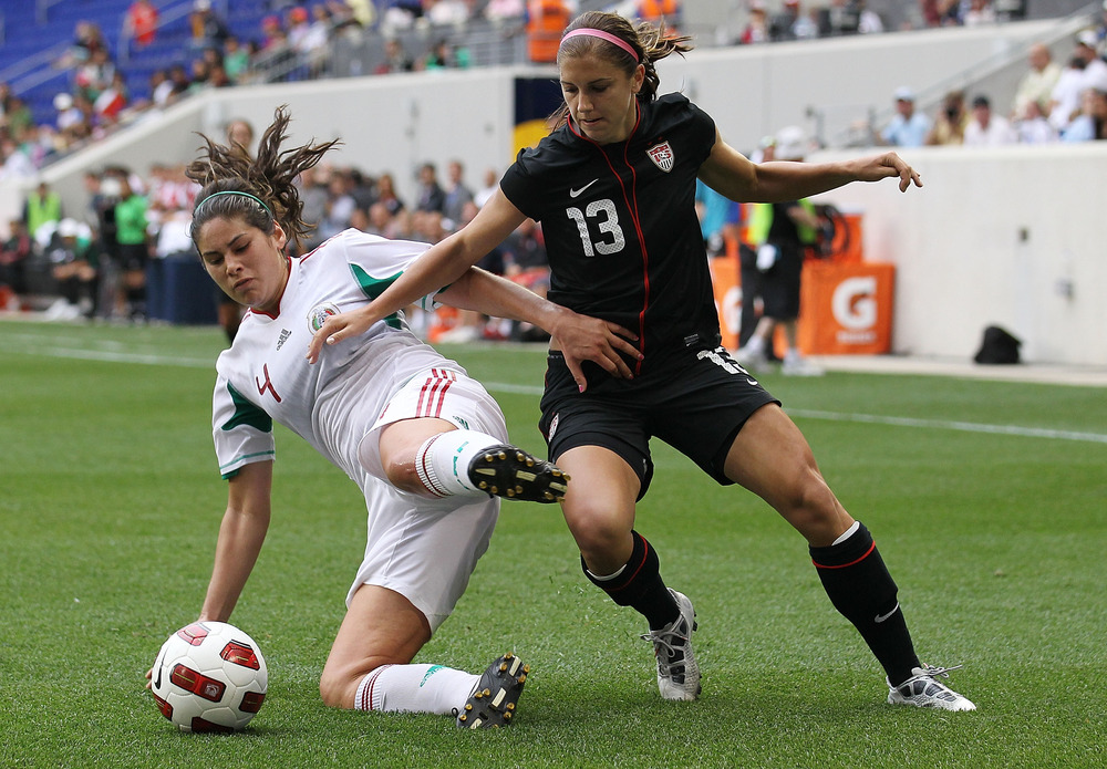 HARRISON, NJ - JUNE 05: Alex Morgan #13 of the United States challenges Alina Garciamendez #4 of Mexico during their International Friendly at Red Bull Arena on June 5, 2011 in Harrison, New Jersey.  (Photo by Nick Laham/Getty Images)