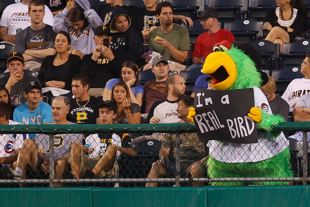 PITTSBURGH - AUGUST 03:  The Pittsburgh Pirates parrott mascot holds up a sign in the outfield during the game against the Chicago Cubs on August 3, 2011 at PNC Park in Pittsburgh, Pennsylvania.  (Photo by Jared Wickerham/Getty Images)