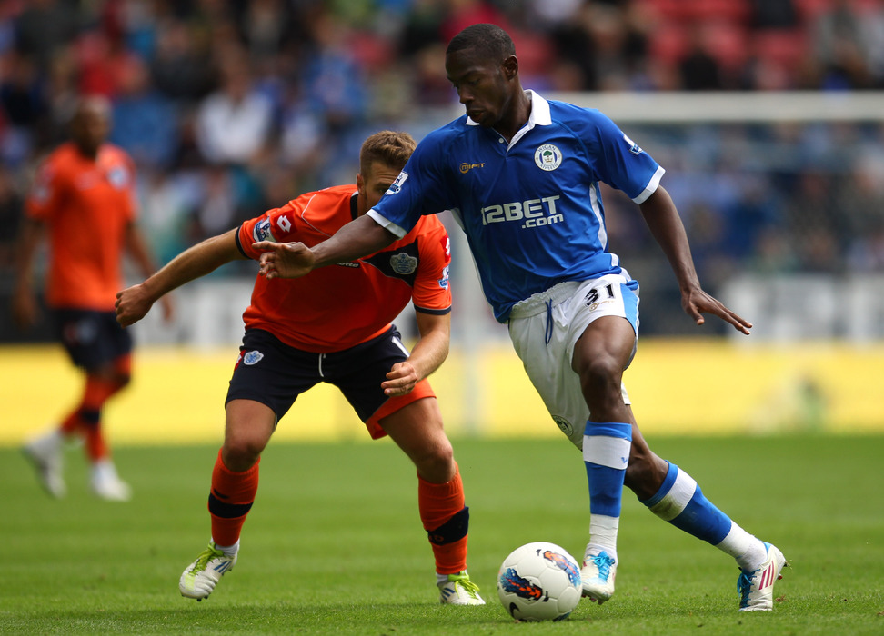 Maynor Figueroa of Wigan Athletic shields the ball from Akos Buzsaky of Queens Park Rangers during the Barclays Premier League match between Wigan Athletic and Queens Park Rangers at the DW Stadium.