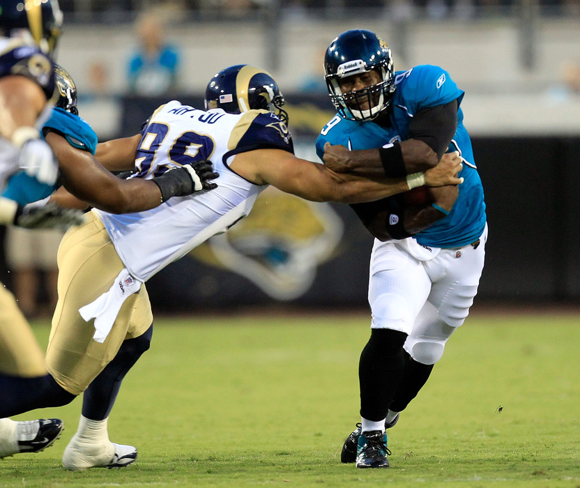JACKSONVILLE, FL - SEPTEMBER 01:   C.J. Ah You #99 of the St. Louis Rams tackles David Garrard #9 of the Jacksonville Jaguars during a game at EverBank Field on September 1, 2011 in Jacksonville, Florida.  (Photo by Sam Greenwood/Getty Images)