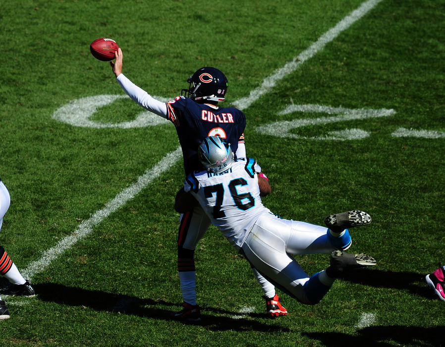 ATLANTA - OCTOBER 2: Jay Cutler #6 of the Chicago Bears flips a pass against Greg Hardy #76 of the Carolina Panthers at Soldier Field on October 2, 2011 in Chicago, Illinois. (Photo by Scott Cunningham/Getty Images)