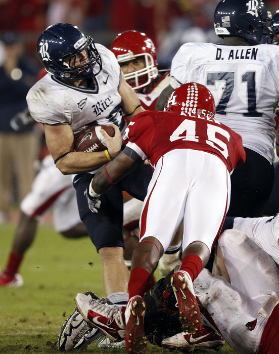 HOUSTON - OCTOBER 27:  Quarterback Turner Petersen #18 of the Rice Owls is tackled by linebacker Lloyd Allen #45 of the Houston Cougars at Robertson Stadium on October 27, 2011 in Houston, Texas.  (Photo by Bob Levey/Getty Images)