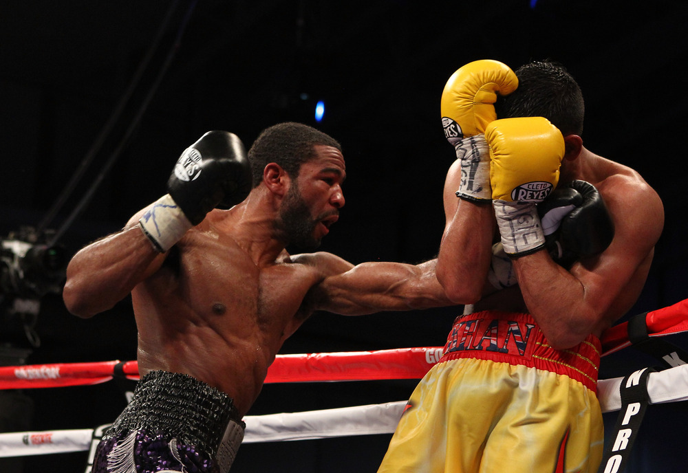 WASHINGTON, DC - DECEMBER 10:  Lamont Peterson punches Amir Khan during their WBA Super Lightweight and IBF Junior Welterweight title fight at Washington Convention Center on December 10, 2011 in Washington, DC.  (Photo by Al Bello/Getty Images)