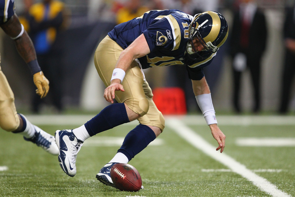 ST. LOUIS, MO - JANUARY 1: Kellen Clemens #10 of the St. Louis Rams fumbles the ball against the San Francisco 49ers at the Edward Jones Dome on January 1, 2012 in St. Louis, Missouri.  (Photo by Dilip Vishwanat/Getty Images)