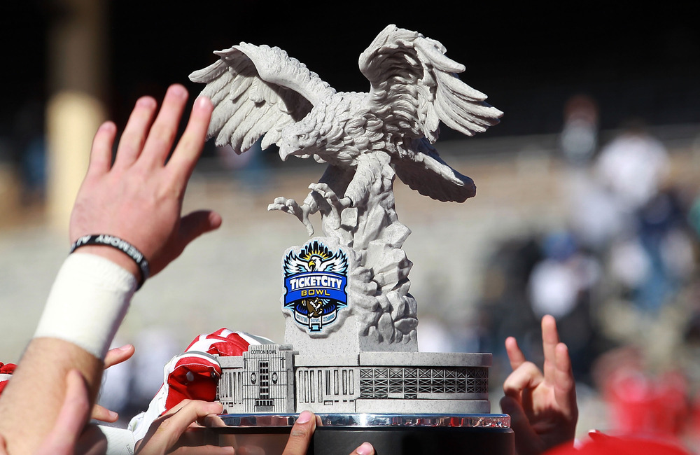DALLAS, TX - JANUARY 02:  The Houston Cougars raise the TicketCity Bowl trophy after a 30-14 win against the Penn State Nittany Lions at Cotton Bowl Stadium on January 2, 2012 in Dallas, Texas.  (Photo by Ronald Martinez/Getty Images)