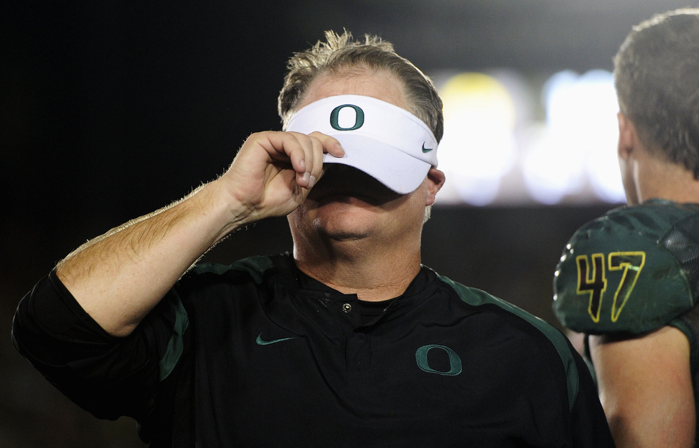 PASADENA, CA - JANUARY 02:  Head coach Chip Kelly of the Oregon Ducks covers his face after the Ducks defeat the Wisconsin Badgers 45-38 at the 98th Rose Bowl Game on January 2, 2012 in Pasadena, California.  (Photo by Harry How/Getty Images)