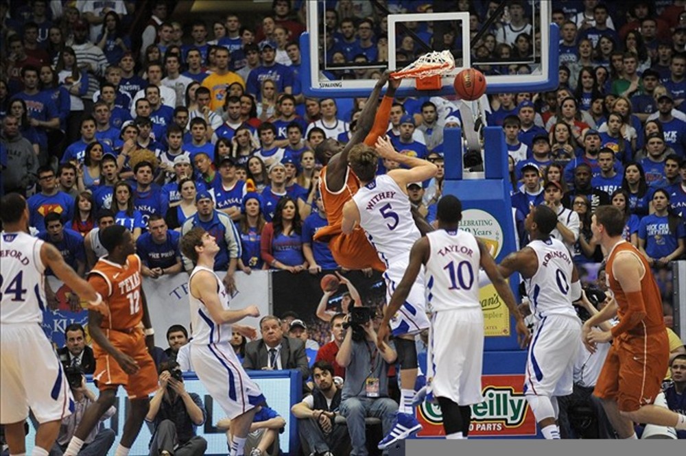 March 03, 2012; Lawrence, KS, USA; Texas Longhorns forward/center Alexis Wangmene (20) dunks the ball as Kansas Jayhawks center Jeff Withey (5) defends in the first half at Allen Fieldhouse. Mandatory Credit: Denny Medley-US PRESSWIRE