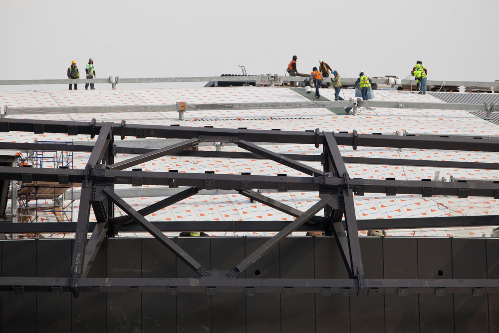Construction workers create the roof hatch in Brooklyn where Jean-Claude Van Damme will enter.