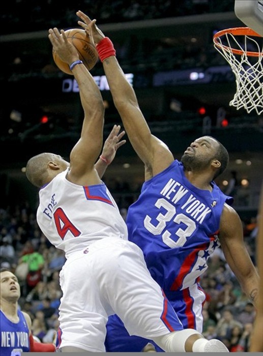 Mar 7, 2012; Newark, NJ, USA;  New Jersey Nets power forward Shelden Williams (33) blocks the shot of Los Angeles Clippers guard Randy Foye (4) at the Prudential Center.  Mandatory Credit: Jim O'Connor-US PRESSWIRE