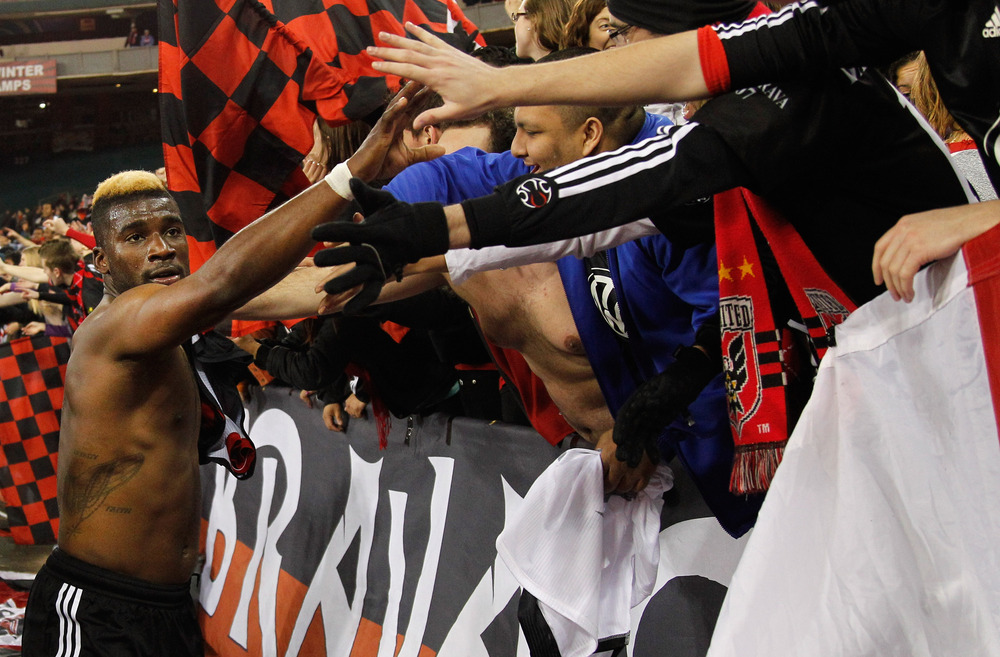 WASHINGTON, DC - MARCH 30: Brandon McDonald #4 of the D.C. United celebrates with fans after defeating the FC Dallas 4-1 at RFK Stadium on March 30, 2012 in Washington, DC.  (Photo by Rob Carr/Getty Images)