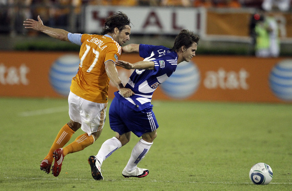 HOUSTON - MAY 05:  Zach Loyd #19 of FC Dallas is harassed by Mike Chabala #17 of the Houston Dynamo at Robertson Stadium on May 5, 2010 in Houston, Texas.  (Photo by Bob Levey/Getty Images)