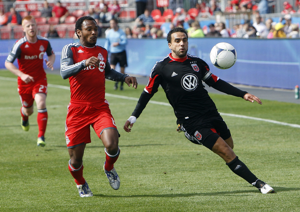 TORONTO, CANADA - MAY 5:  Julian de Guzman #6 of Toronto FC battles for the ball with Dwayne De Rosario #7 of DC United during MLS action at BMO Field May 5, 2012 in Toronto, Ontario, Canada.  (Photo by Abelimages/Getty Images)