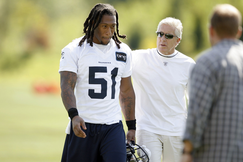 May 11, 2012; Renton, WA, USA; Seattle Seahawks head coach Pete Carroll speaks with defensive end Bruce Irvin (51) following a minicamp practice at the Virginia Mason Athletic Center. Mandatory Credit: Joe Nicholson-US PRESSWIRE