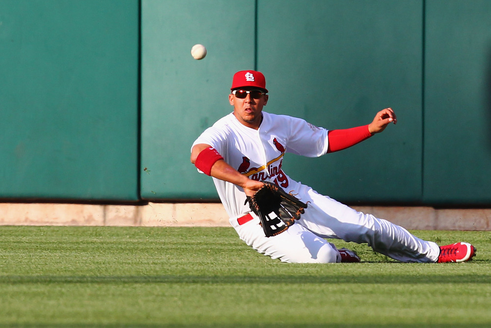 ST. LOUIS, MO - MAY 14: Jon Jay #19 of the St. Louis Cardinals attempts to catch a deep fly ball against the Chicago Cubs at Busch Stadium on May 14, 2012 in St. Louis, Missouri.  (Photo by Dilip Vishwanat/Getty Images)