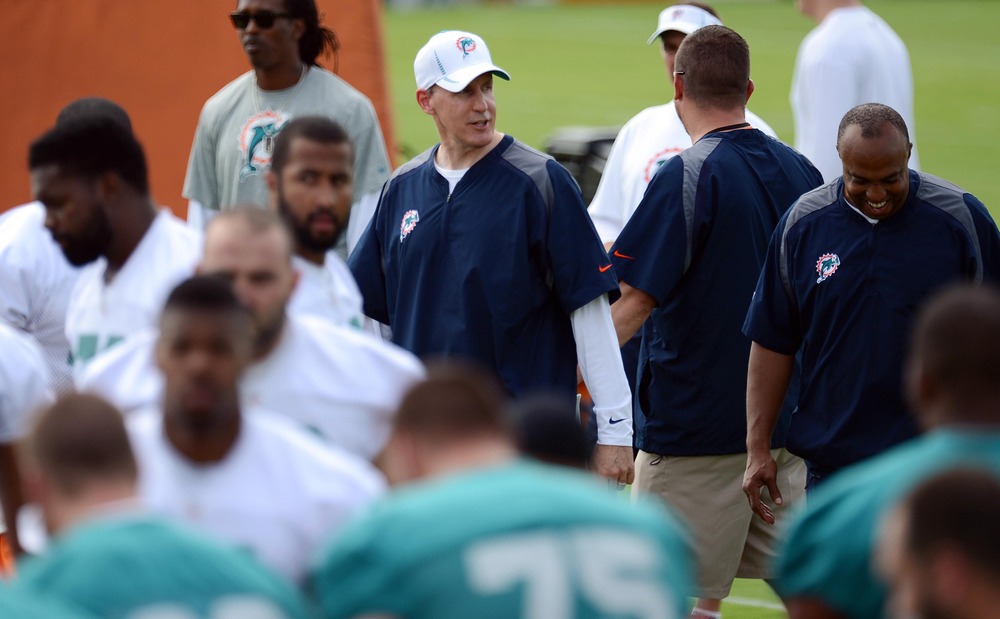 May 22, 2012; Davie, FL, USA; Miami Dolphins head coach Joe Philbin (middle) looks on during organized team activities at the Dolphins training facility. Mandatory Credit: Steve Mitchell-US PRESSWIRE