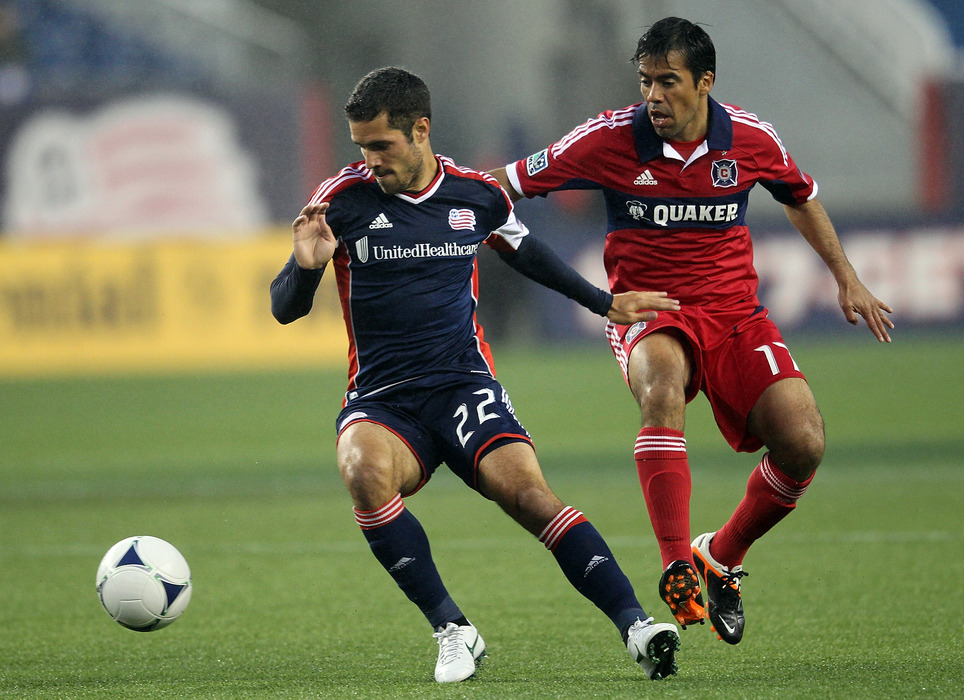 FOXBORO, MA - JUNE 2:  Benny Feilhaber #22 of the New England Revolution steal the ball from Daniel Paladini #11 of the Chicago Fire at Gillette Stadium on June 2, 2012 in Foxboro, Massachusetts. (Photo by Jim Rogash/Getty Images)