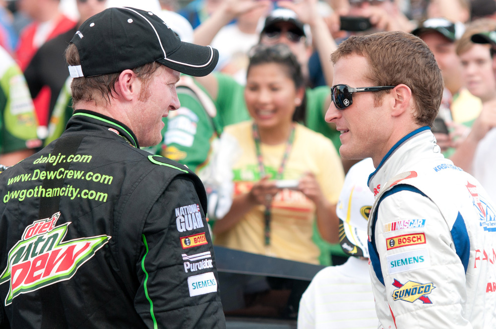 June 17, 2012; Brooklyn, MI, USA; NASCAR Sprint Cup Series driver Dale Earnhardt Jr. (left) is congratulated by driver Kasey Kahne (right) after the Quicken Loans 400 at Michigan International Speedway. Mandatory Credit: Tim Fuller-US PRESSWIRE