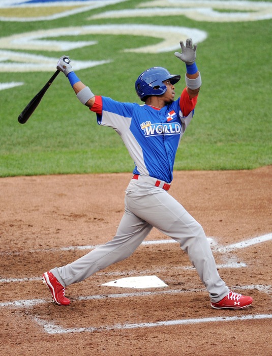 July 8, 2012; Kansas City, MO, USA; World outfielder Oscar Taveras drives in a run with a sacrifice fly during the third inning of the 2012 All Star Futures Game at Kauffman Stadium.  Mandatory Credit: Peter G. Aiken-US PRESSWIRE