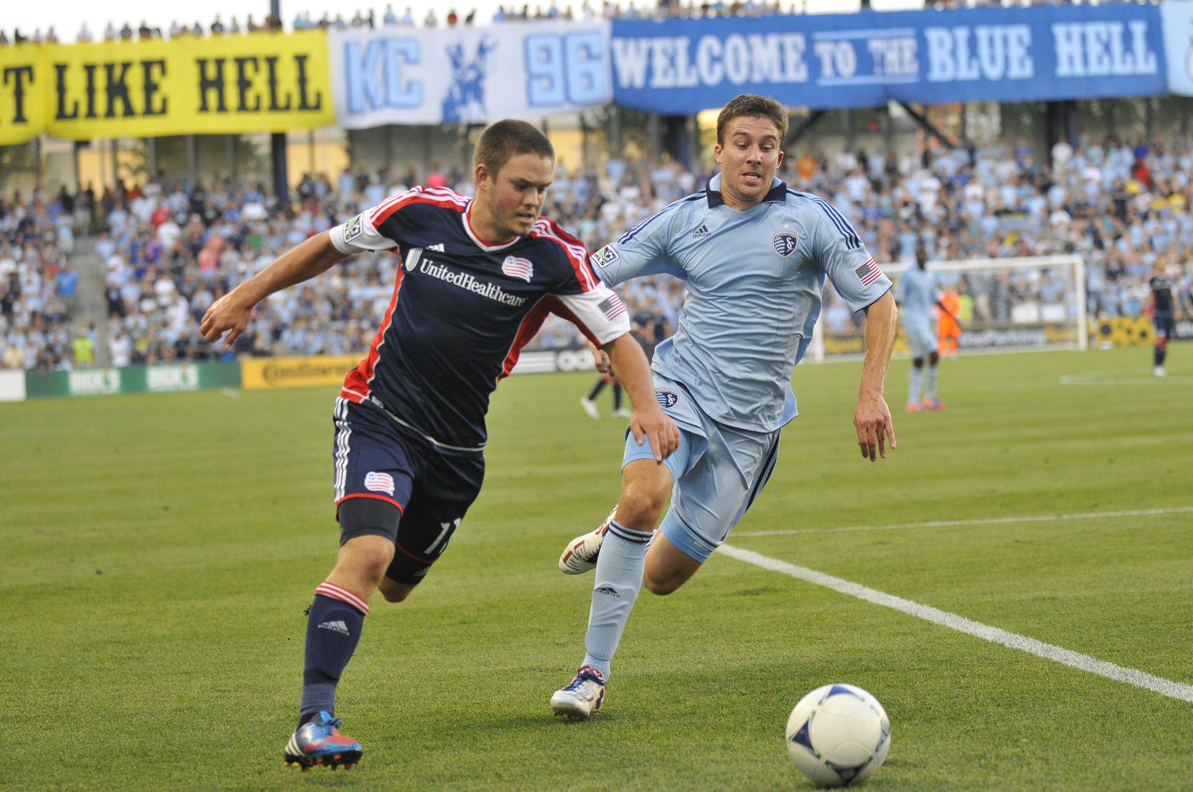 July 21, 2012; New England Revolution midfielder Kelyn Rowe (11) and Sporting KC defender Matt Besler (5) fight for the ball during the first half of the soccer match at LIVESTRONG Sporting Park.  Mandatory Credit: Denny Medley-US PRESSWIRE