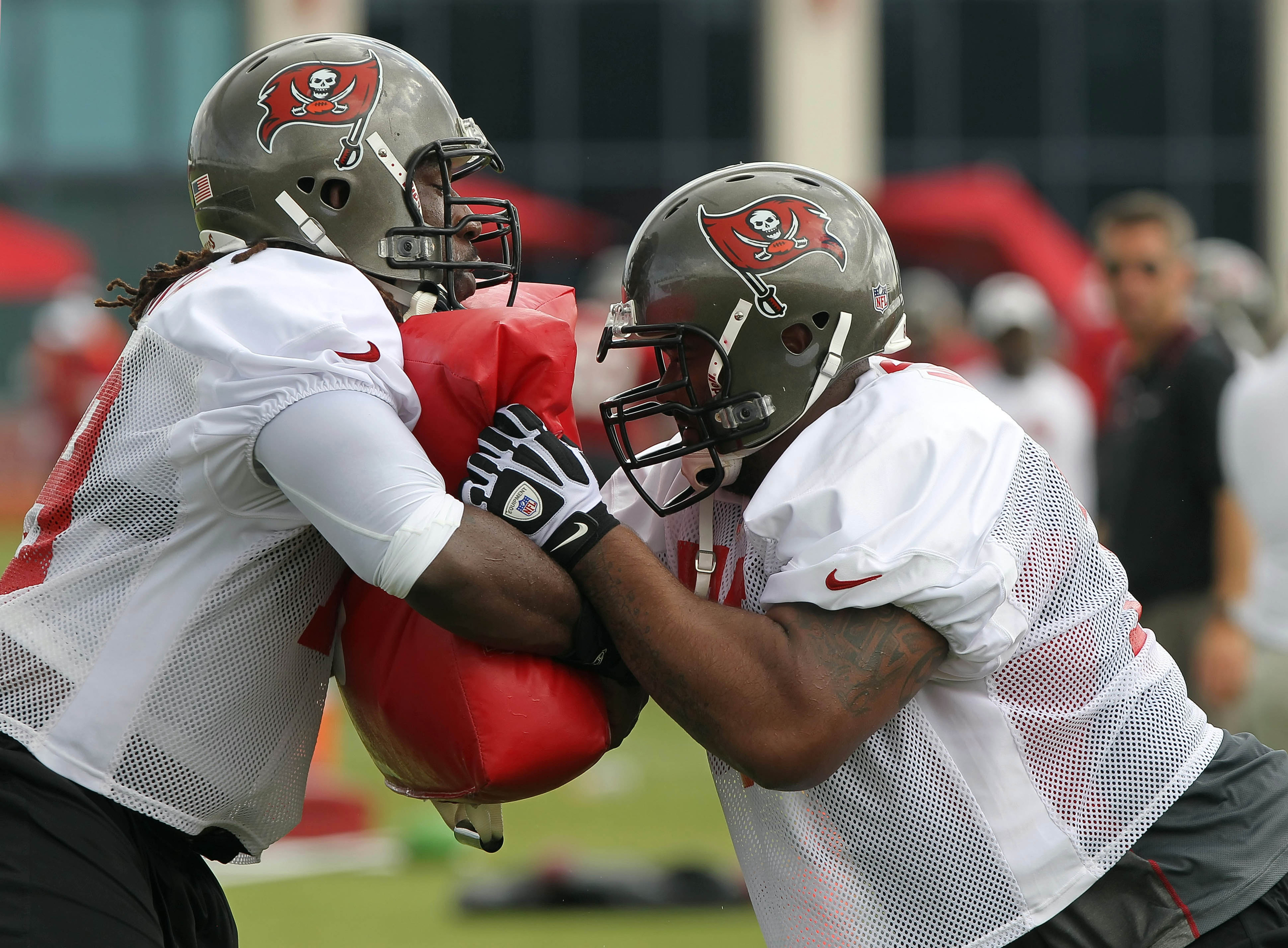 July 28, 2012; Tampa, FL, USA; Tampa Bay Buccaneers offensive guard Carl Nicks (77) (right) and offensive tackle Jamon Meredith (79) (left) practice drills during training camp at One Buc Place. Mandatory Credit: Kim Klement-US PRESSWIRE